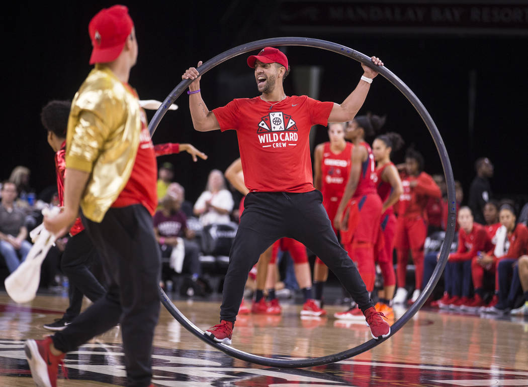 Las Vegas Aces Wild Card Crew member Adam Moss, middle, entertains the crowd in the second quar ...