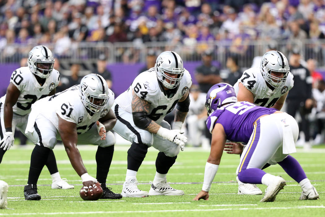 Oakland Raiders center Rodney Hudson (61) prepares to hike the football as guard Richie Incogni ...