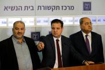 Members of the Joint List Ayman Odeh, center, speaks to the press in the presence of Ahmad Tibi ...