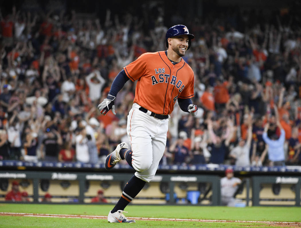 Houston Astros' George Springer rounds the bases after hitting a solo home run off Los Angeles ...