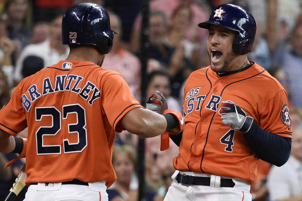 Houston Astros' George Springer, right, celebrates his two-run home run off Los Angeles Angels ...