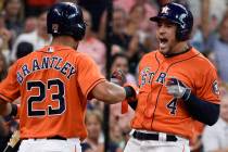 Houston Astros' George Springer, right, celebrates his two-run home run off Los Angeles Angels ...