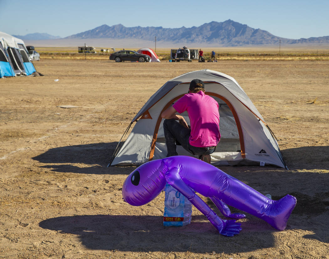 A festivalgoer starts to pack up his tent in the near-empty camping area during the Alienstock ...