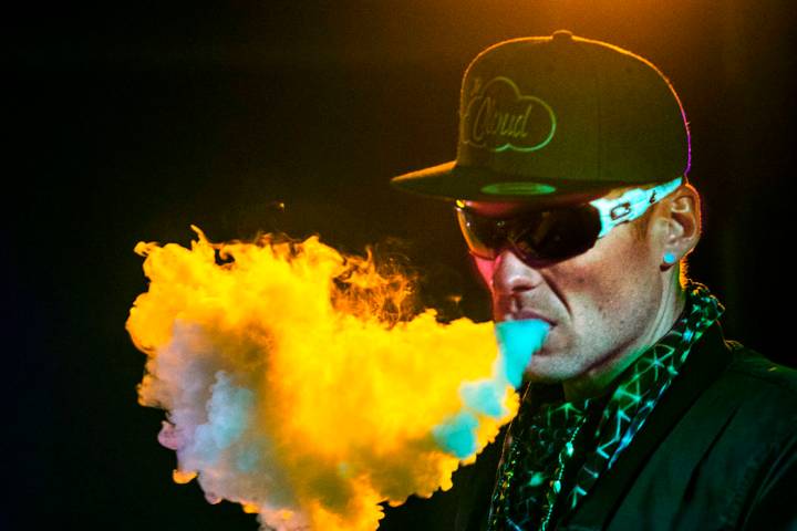 DJ Karn Elofson of Sweden controls the laser light show for performers on the main stage during ...