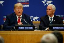Vice President Mike Pence listens as President Donald Trump speaks at an event on religious fre ...
