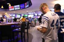 People wait in line to place bets at Winner's Circle sporstbook in Indianapolis, Ind., Sunday, ...