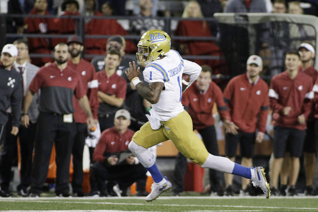 UCLA quarterback Dorian Thompson-Robinson (1) runs with the ball during the second half of an N ...