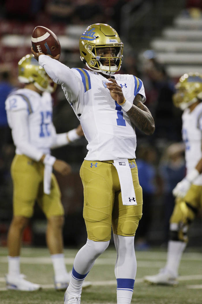 UCLA quarterback Dorian Thompson-Robinson (1) throws a pass during warm ups before an NCAA coll ...