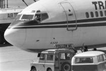 FILE - In this Wednesday, June 19, 1985 file photo, a hijacker points a weapon toward an ABC ne ...