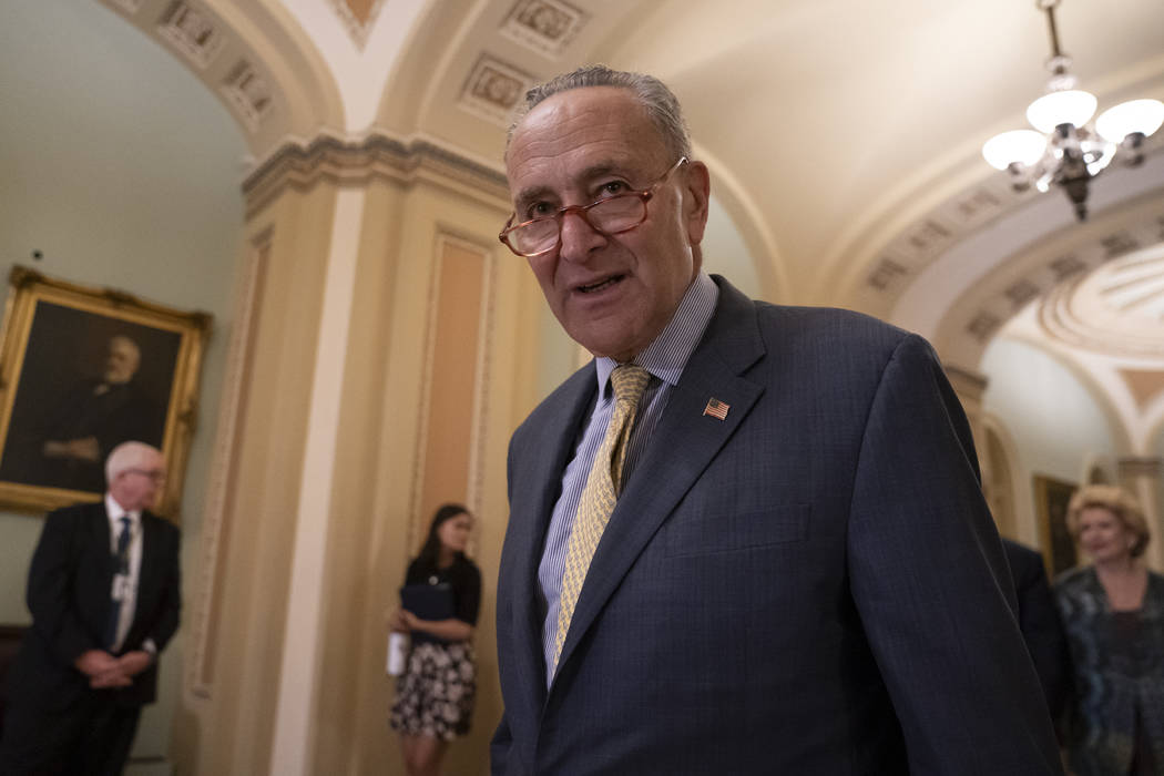 Senate Minority Leader Chuck Schumer, D-N.Y., arrives to speak to reporters at a news conferenc ...