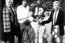 UNLV quarterback Randall Cunningham's No. 12 is retired at halftime of a 1984 game against No. ...