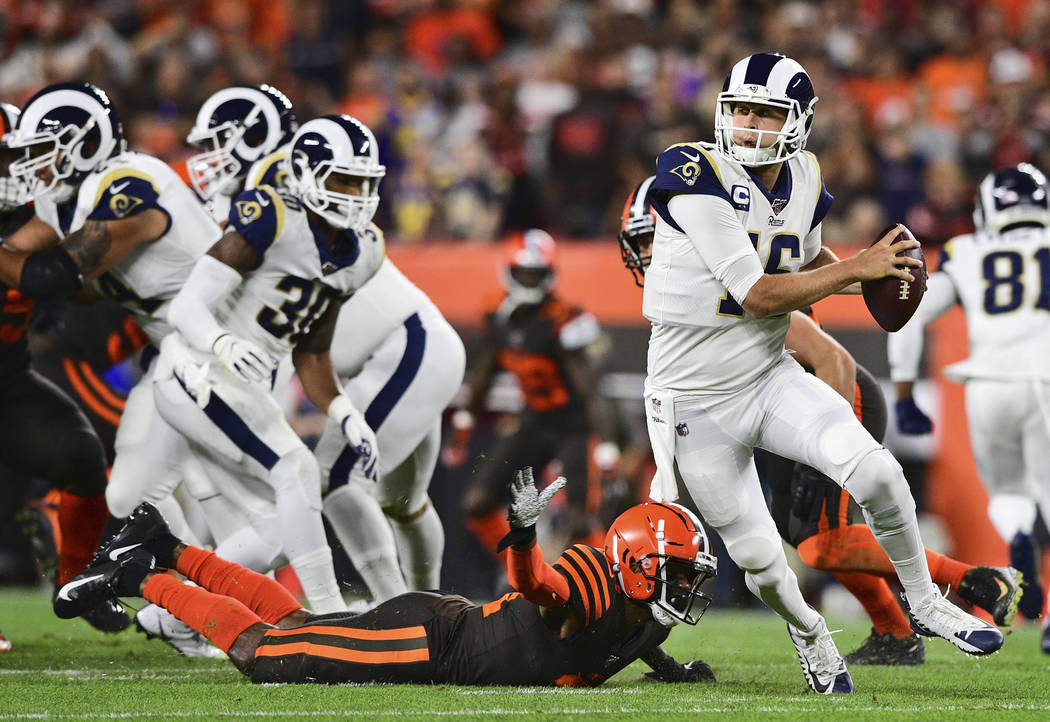 Los Angeles Rams quarterback Jared Goff (16) scrambles during the first half of an NFL football ...