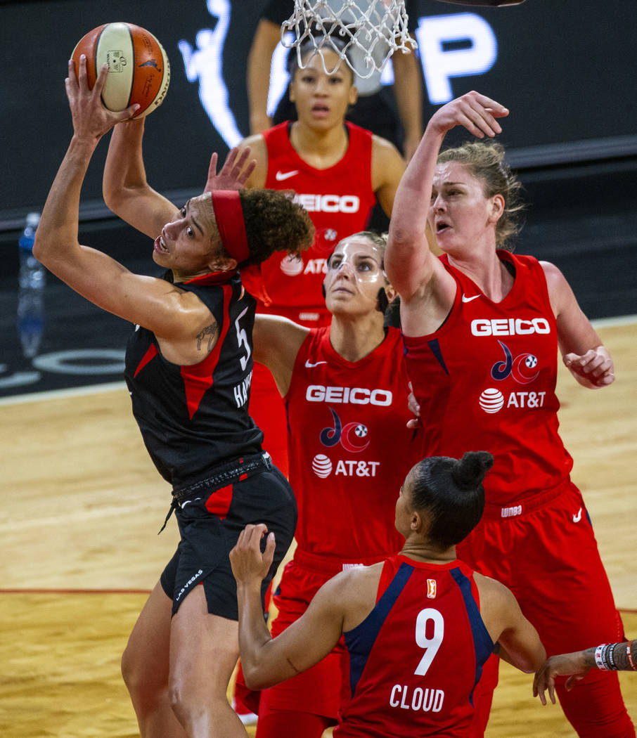 Las Vegas Aces forward Dearica Hamby (5) battles multiple Washington Mystics defenders during t ...