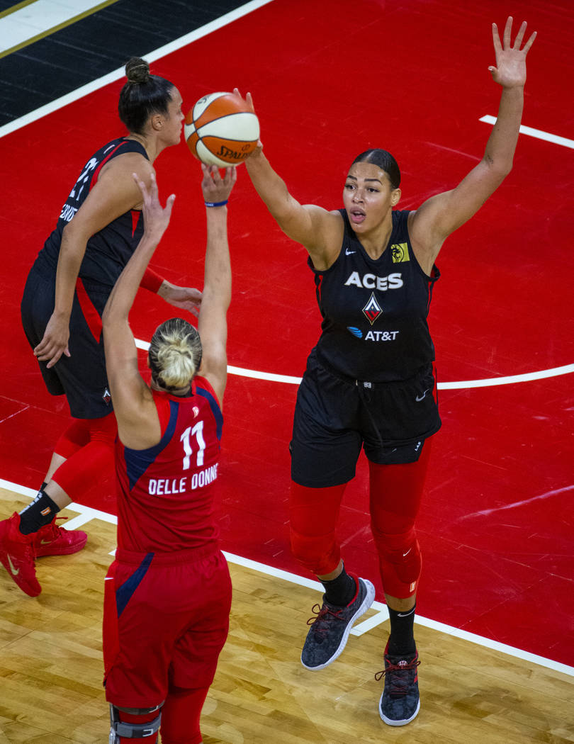 Washington Mystics forward Elena Delle Donne (11, left) has a shot deflected by Las Vegas Aces ...