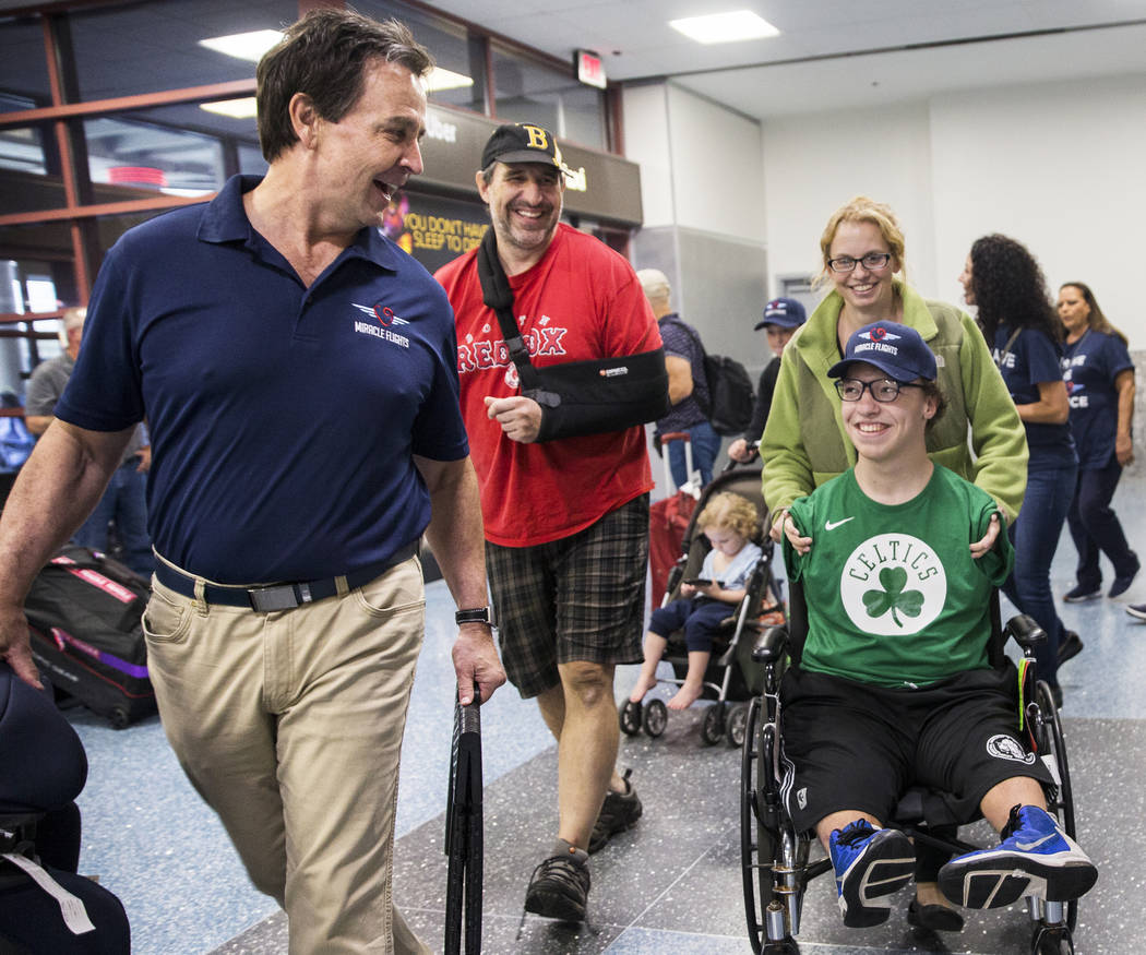 Miracle Flight CEO Mark Brown, left, escorts John, Misty and Michael Perrino, 16, from Mas ...