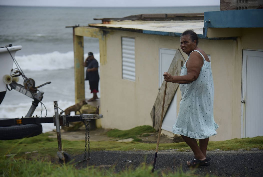 Irma Torres, a resident of the El Negro coastal sector, walks outside her home before the arriv ...