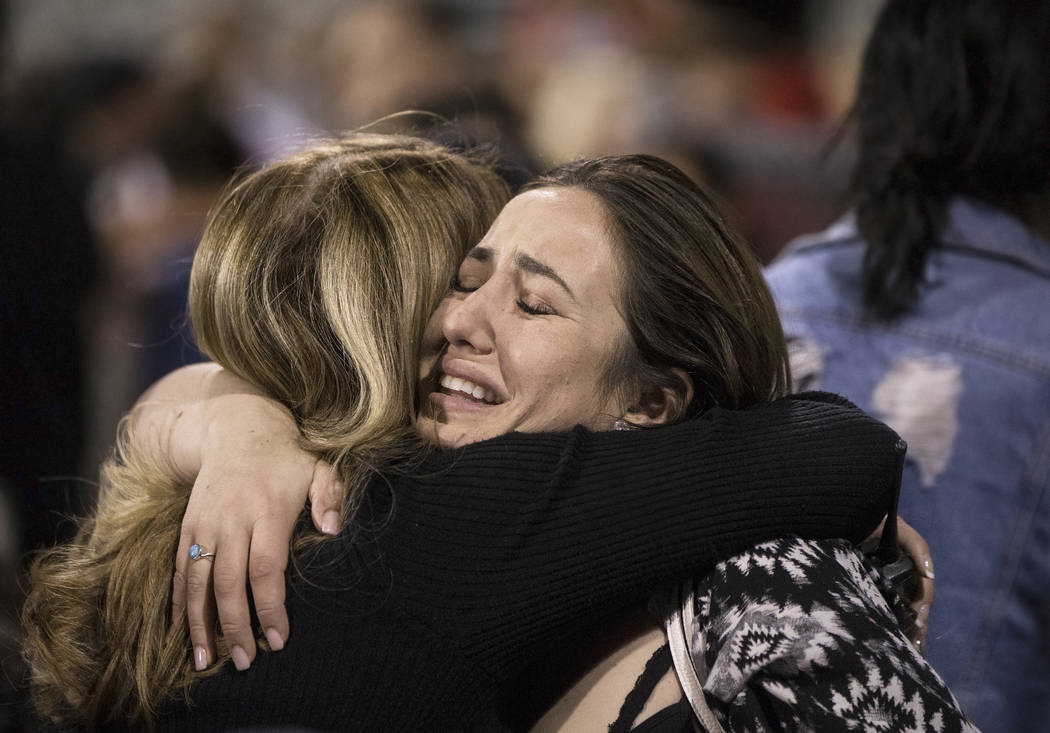 Allie Rossi, sister of A.J. Rossi, breaks down at the conclusion of a vigil for Centennial High ...