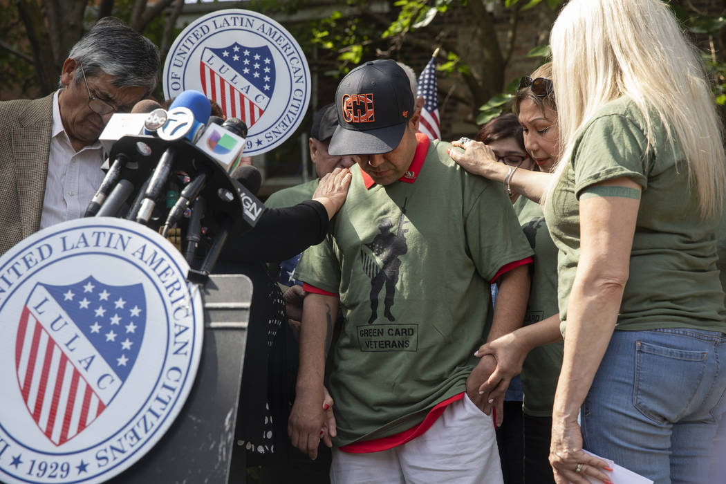 United States Army veteran Miguel Perez Jr. receives a blessing by friends and family at a news ...