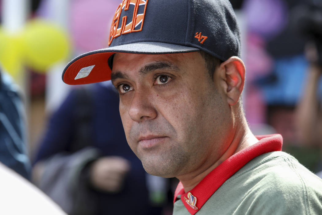Miguel Perez Jr. listens to a supporter speaking at a news conference in Chicago on Tuesday, Se ...