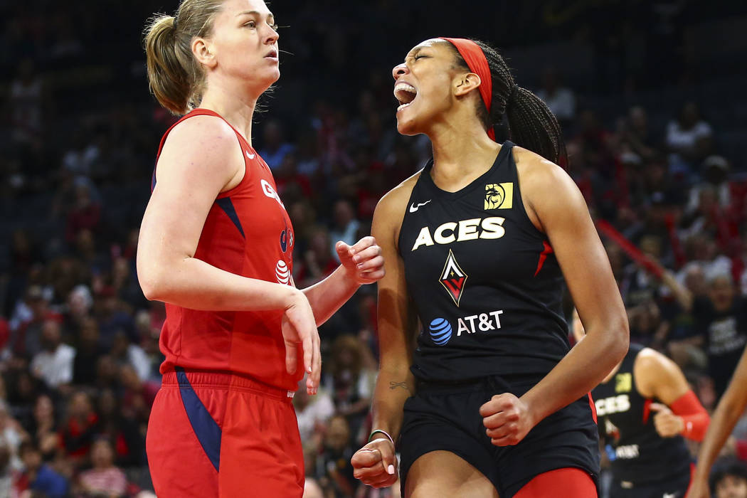 Las Vegas Aces' center A'ja Wilson, right, reacts after drawing a foul in front of Washington M ...