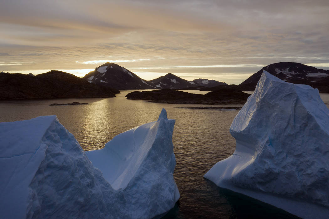 An Aug. 16, 2019, file photo shows large Icebergs floating as the sun rises near Kulusuk, Green ...