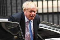Britain's Prime Minster Boris Johnson arrives at 10 Downing Street, in London, on Wednesday, Se ...