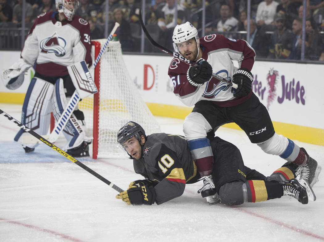 Vegas Golden Knights center Nicolas Roy (10) fights for a puck with Colorado Avalanche right wi ...