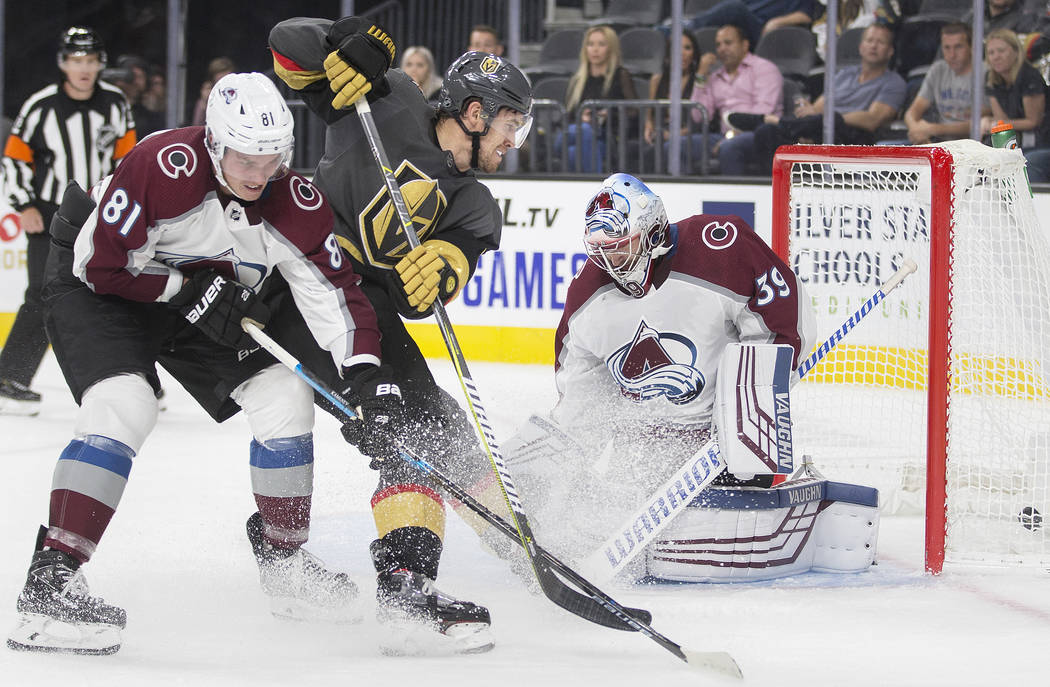 Vegas Golden Knights left wing Curtis McKenzie (11) assists in scoring a third period goal agai ...