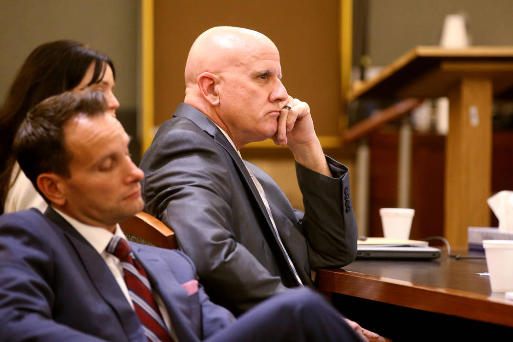 Las Vegas police Lt. James "Tom" Melton, right, listens to closing arguments with his ...