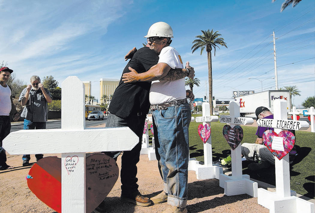 In this Sept. 28, 2018, file photo, cross maker Greg Zanis, right, gets a hug from Mike Warino, ...