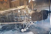 The charred remains of a J3 1941 Piper Cub airplane sits in a hangar following a fire at the Ca ...