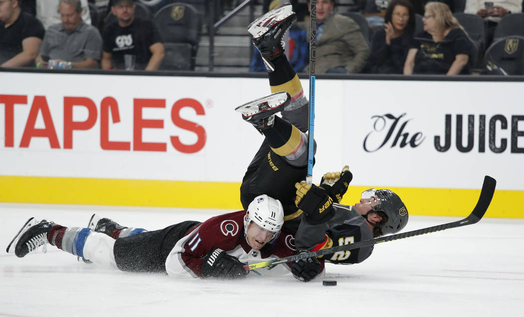 Colorado Avalanche left wing Matt Calvert, left, and Vegas Golden Knights defenseman Dylan Cogh ...