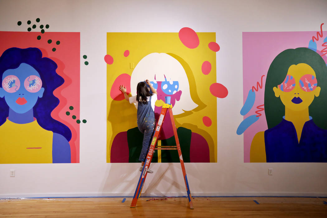 Artist Amanda Phingbodhipakkiya touches up a mural at her show "Connective Tissue" at ...
