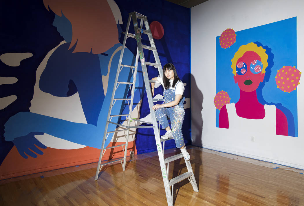 Amanda Phingbodhipakkiya, a neuroscientist-turned-artist, stands in front of her work at her ex ...