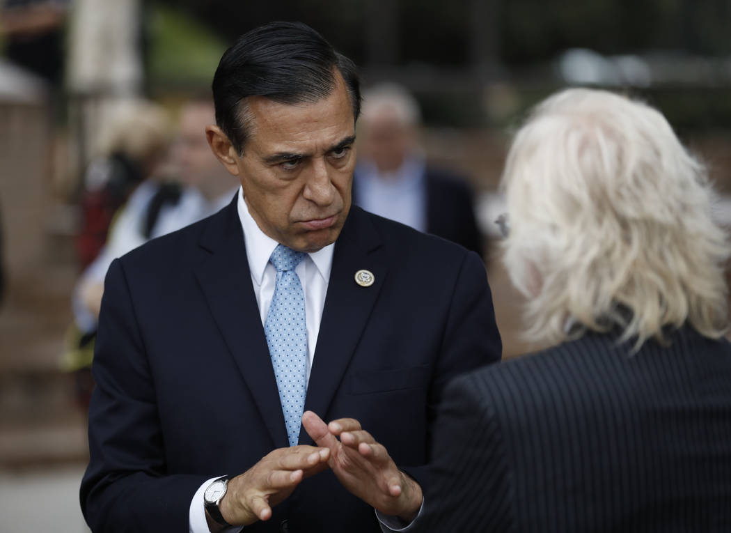 Former congressman Darrell Issa, left, speaks with a reporter after a news conference Thursday, ...