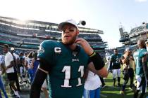 Philadelphia Eagles' Carson Wentz walks off the field after an NFL football game against the De ...