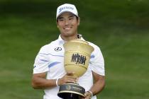 Hideki Matsuyama, from Japan, holds the The Gary Player Cup trophy after the final round of the ...
