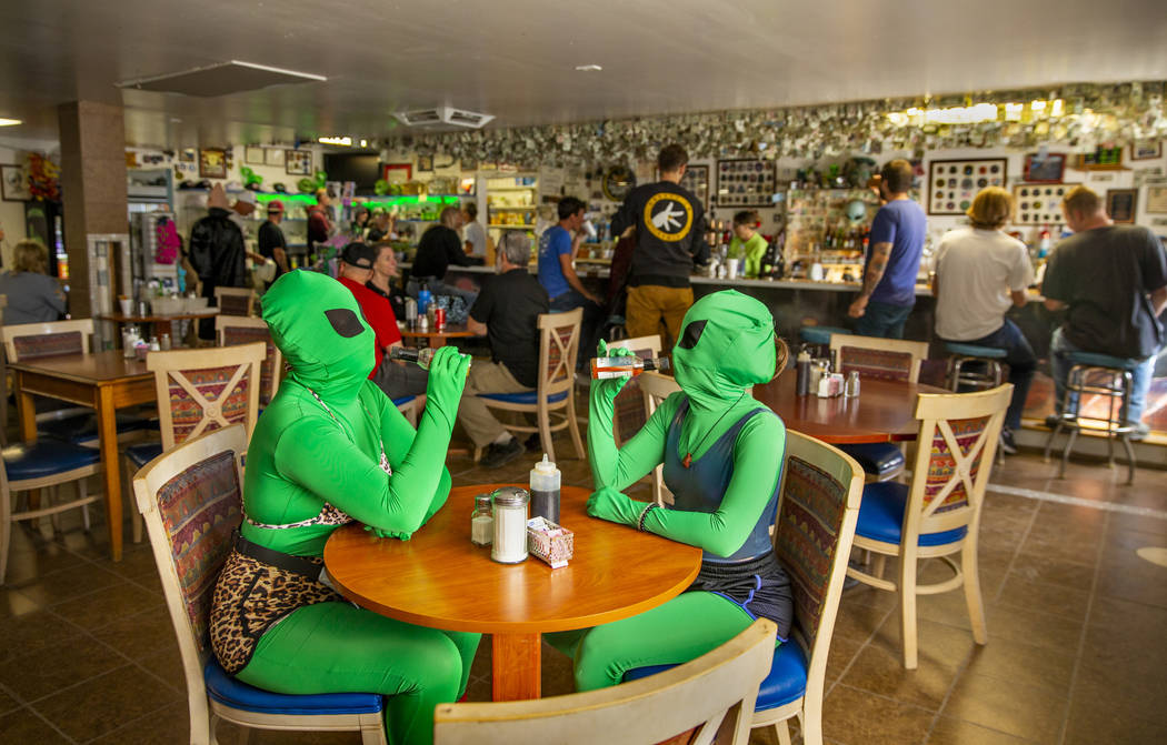 Invader Q-Tip, left, and Invader Stink enjoy a hot sauce breakfast at the Little A'Le'Inn Resta ...