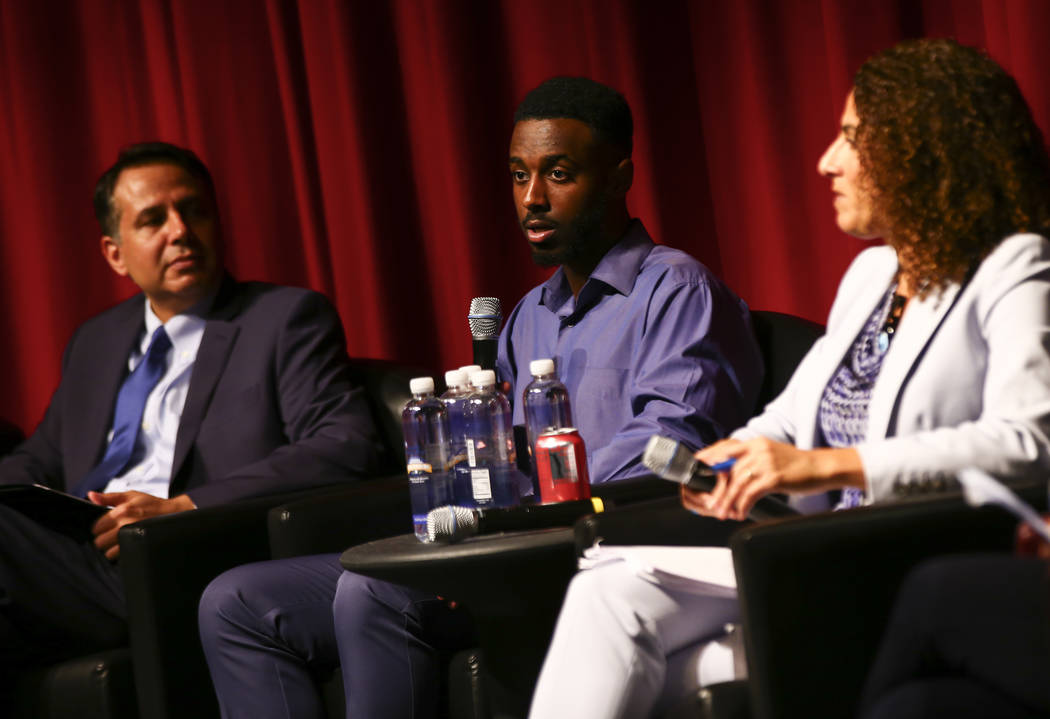 UNLV student Mahir Hussein, president of the UNLV Muslim Student Association, center, speaks du ...