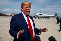 President Donald Trump talks with reporters after arriving at Andrews Air Force Base, Thursday, ...