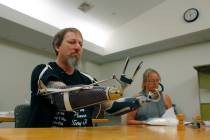 In this Aug. 19, 2019, photo, Greg Manteufel tries out a new prosthetic arm during occupational ...