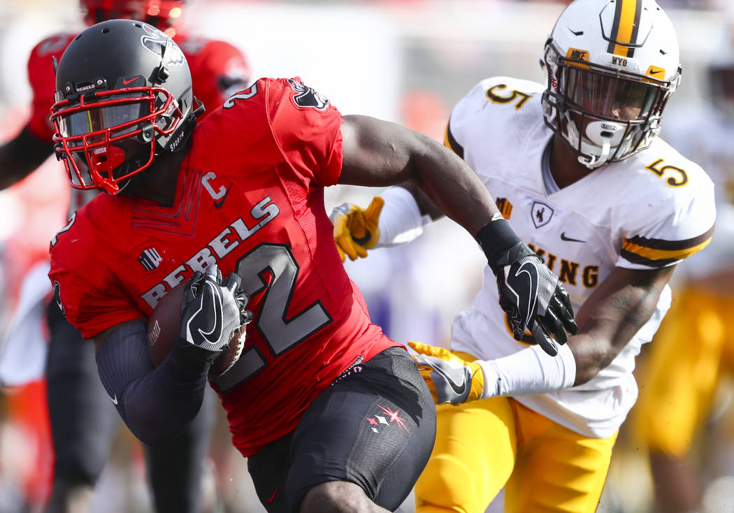 UNLV running back David Greene (22) runs the ball to score a touchdown as Wyoming cornerback Ri ...