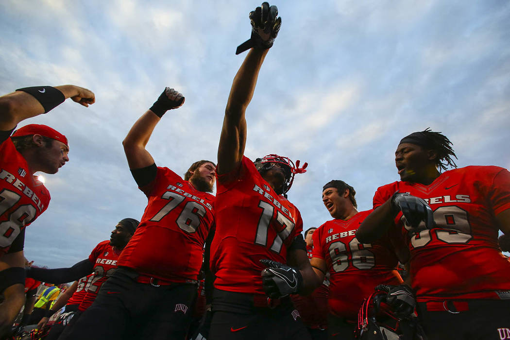 UNLV players celebrate after defeating Wyoming 69-66 in a triple overtime football game at Sam ...