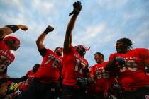 UNLV players celebrate after defeating Wyoming 69-66 in a triple overtime football game at Sam ...