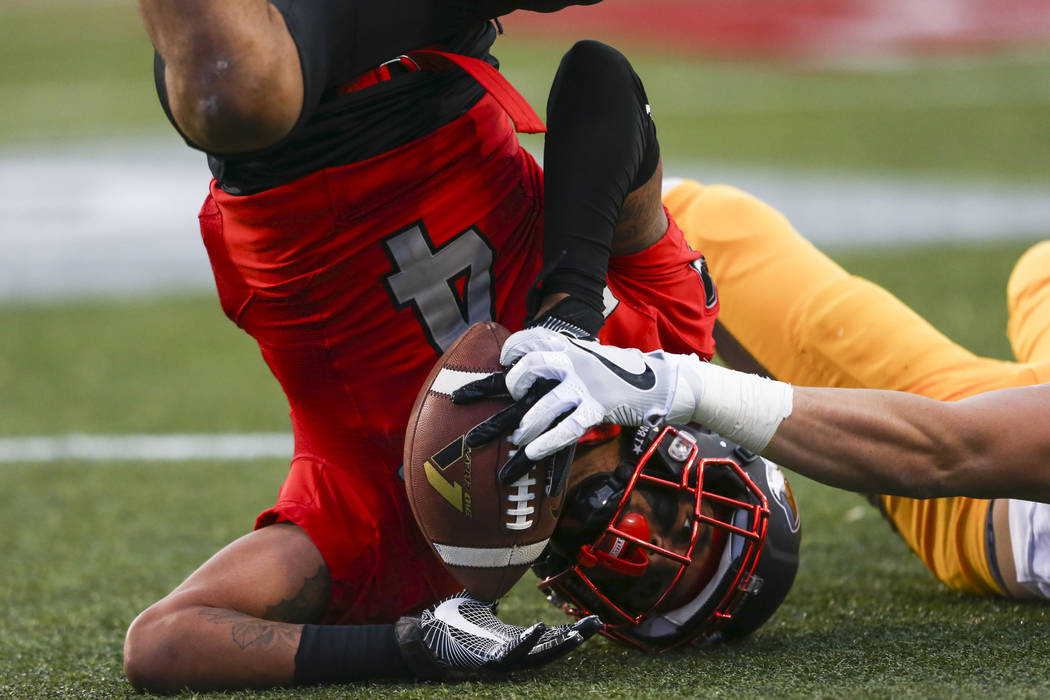 UNLV defensive back Torry McTyer (4) intercepts a pass intended for Wyoming wide receiver Jake ...
