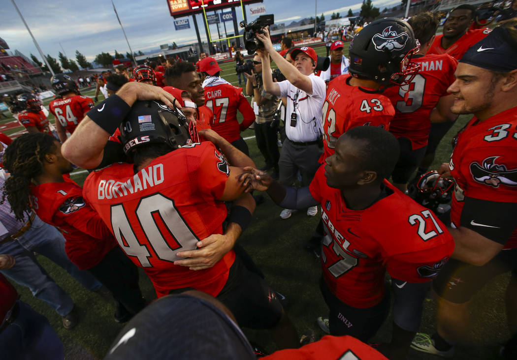 UNLV players celebrate after defeating Wyoming 69-66 in a triple overtime football game at Sam ...