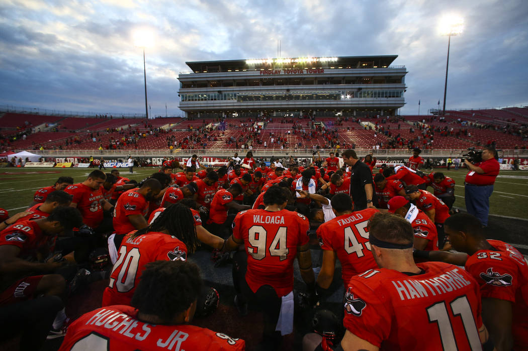 UNLV players huddle after defeating Wyoming 69-66 in a triple overtime football game at Sam Boy ...