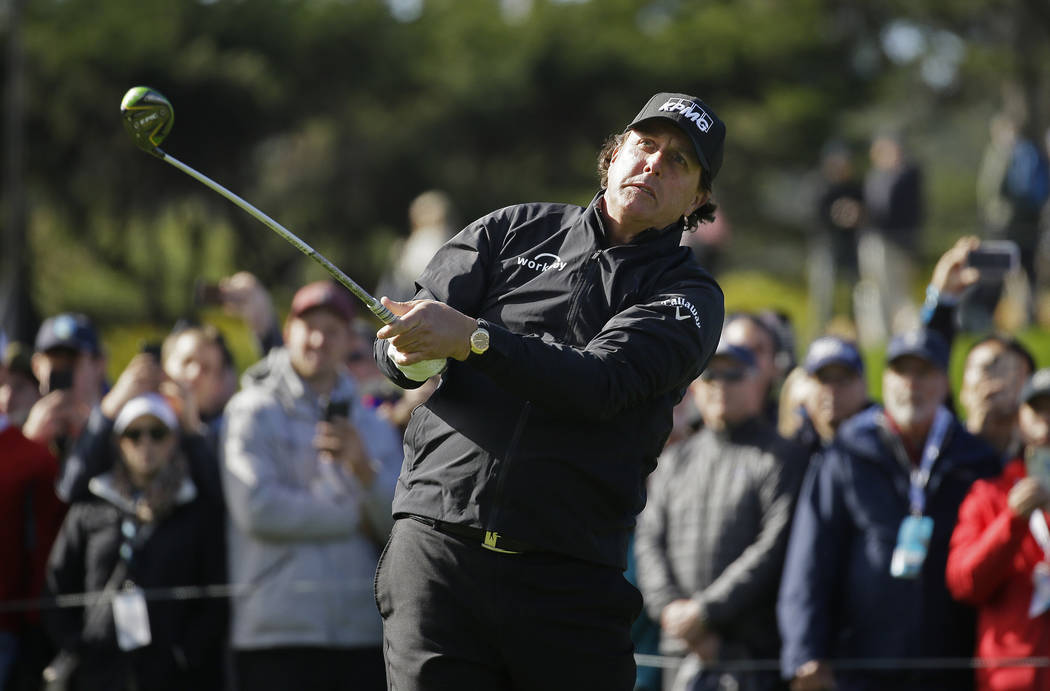 Phil Mickelson follows his drive from the fourth tee of the Pebble Beach Golf Links during the ...