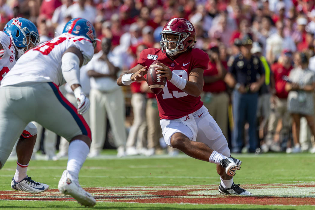 Alabama quarterback Tua Tagovailoa (13) runs looking to throw against Mississippi during the fi ...