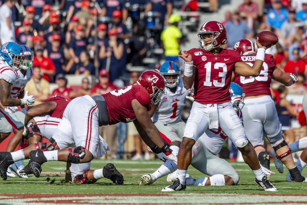 Alabama quarterback Tua Tagovailoa (13) throws to the edge against Mississippi during the first ...